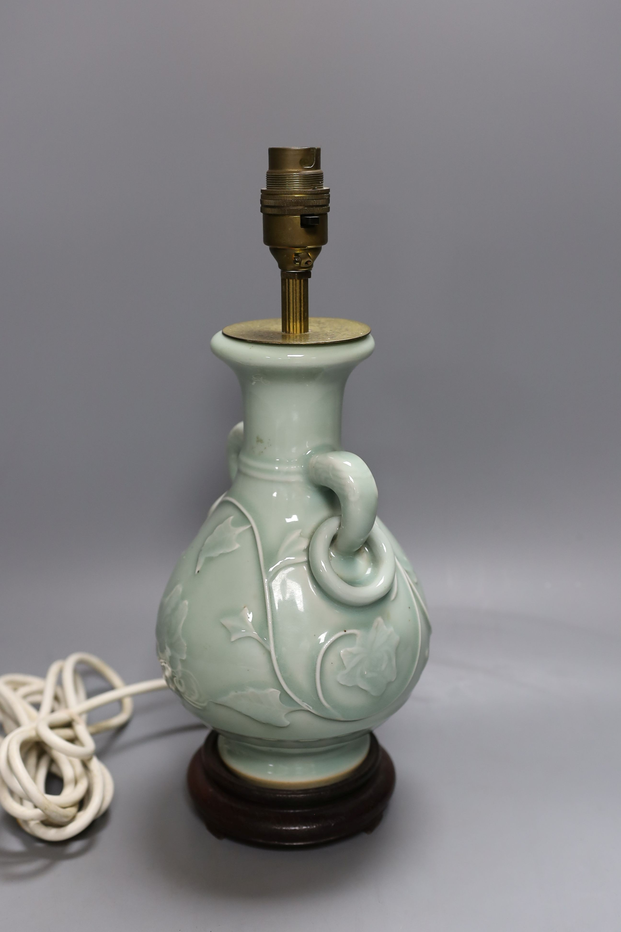A Chinese celadon glazed two handled table lamp